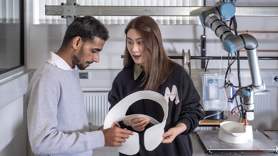 Two students with engineering design and robotic equipment