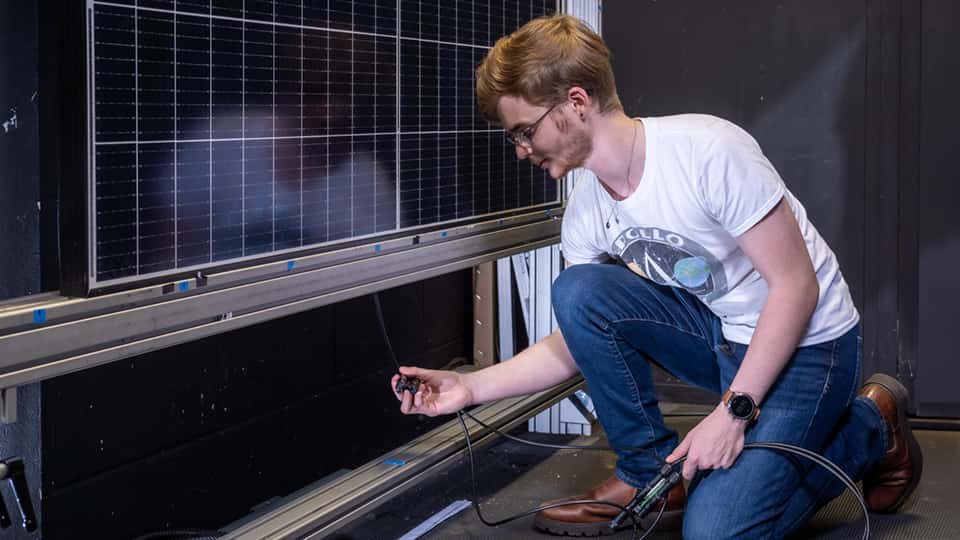 Student working with solar panels in engineering lab