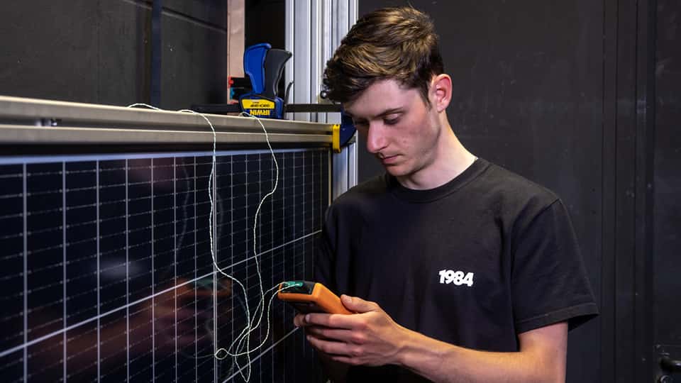 Student working with solar panels in engineering lab