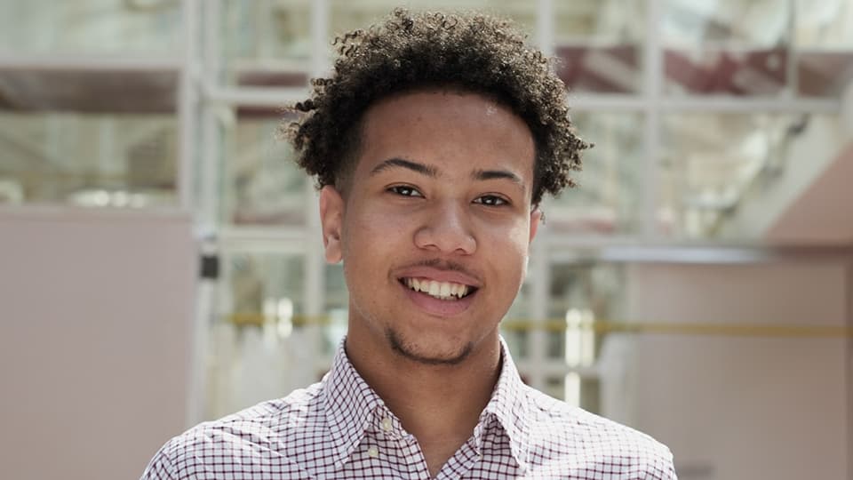 Thomas stood next to a university building