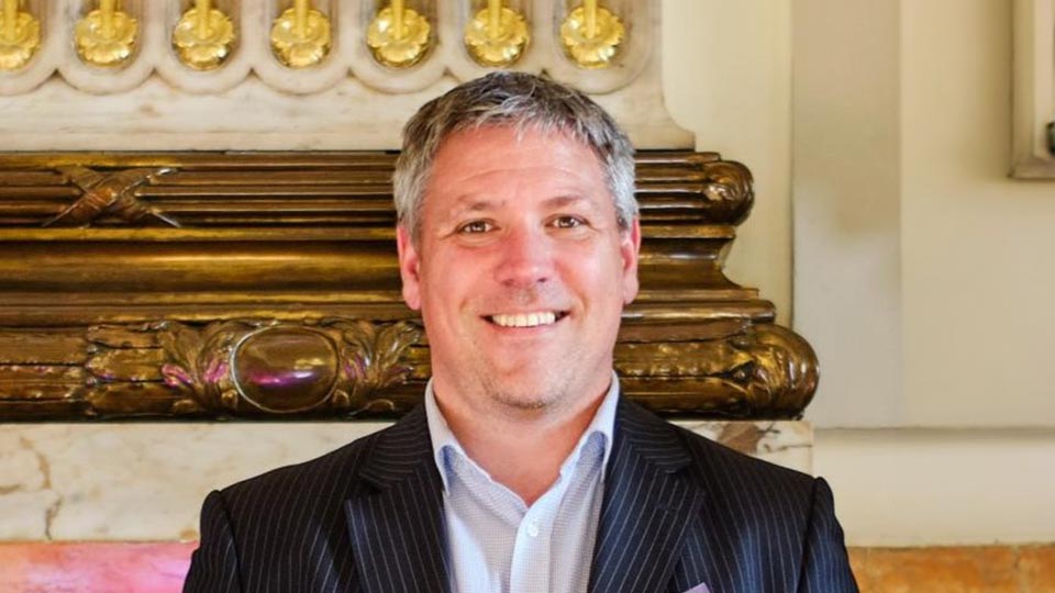 Andy stood in front of wall