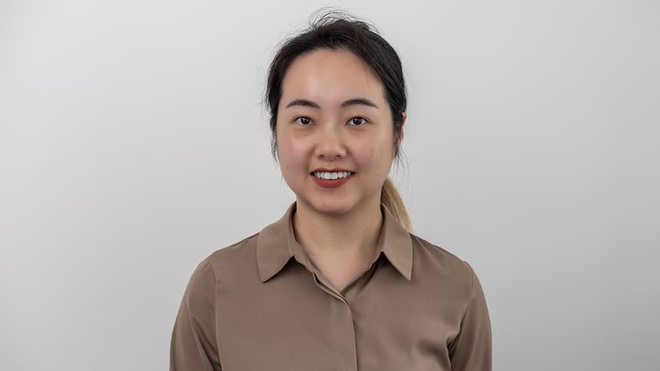 Claire standing against wall