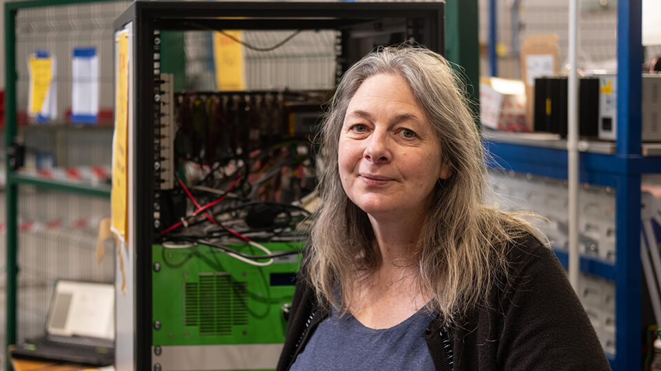 Headshot of Dani Strickland smiling, looking directly into the camera.