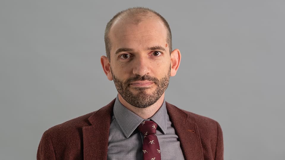 Elliot stood in front of grey background