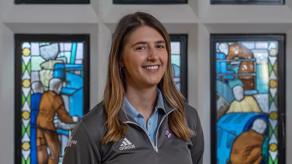 Rebecca stood next to stain glass windows