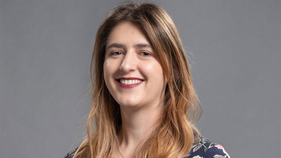 Headshot of Becky, smiling whilst looking directly at the camera.
