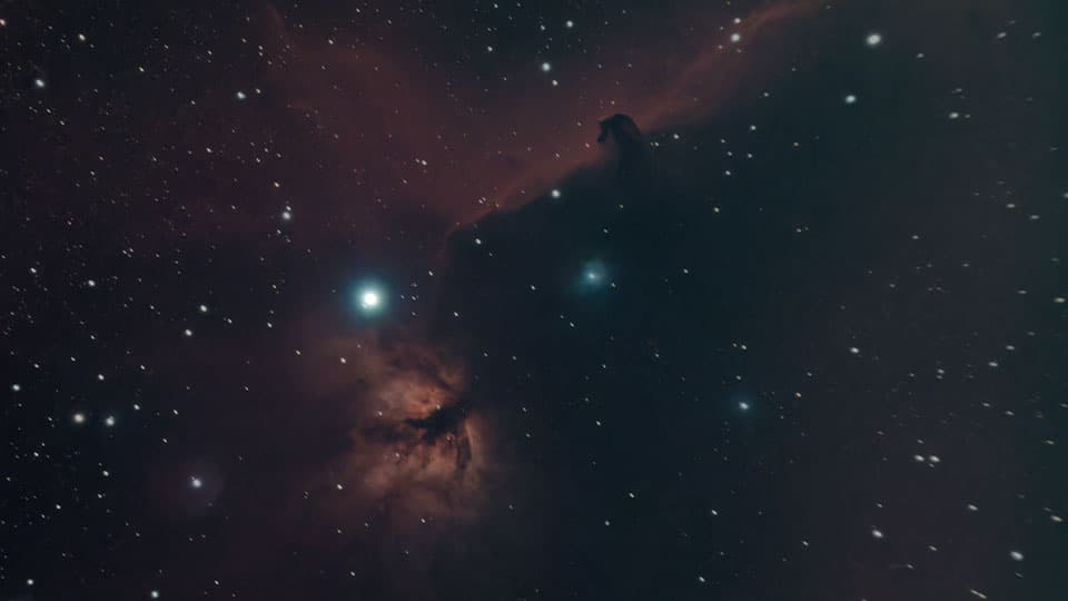 An image of the Horsehead and Flame nebulae, and the star Alnitak. Found within the Orion constellation.