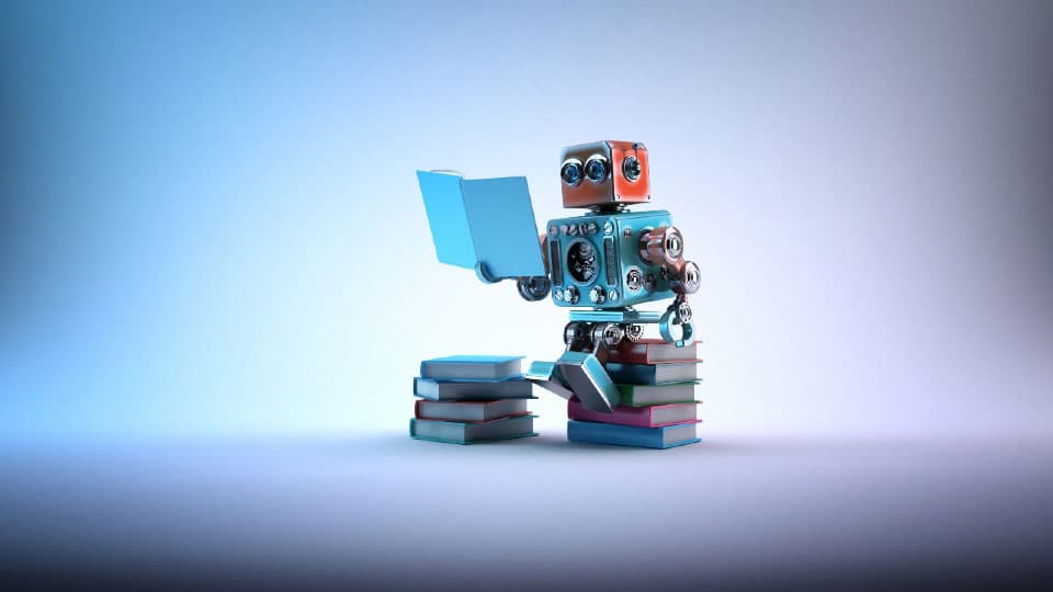Animated image of a robot sat on a pile of books reading a book