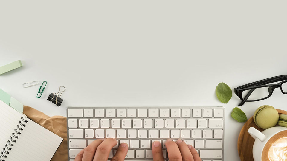 Aerial view of someone typing on a key board