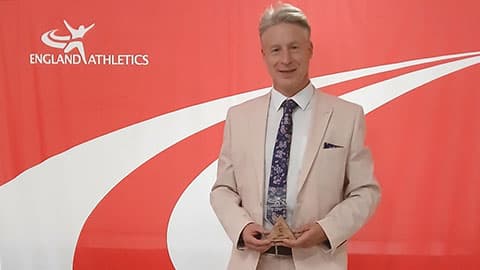 Dr Matt Long holding the award