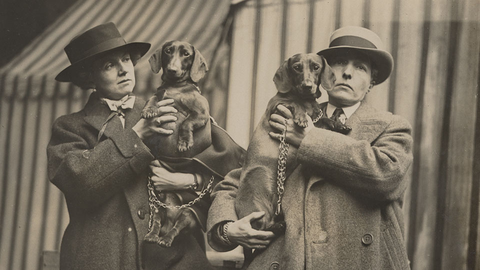 Lady Troubridge and Radclyffe Hall holding their dachshunds
