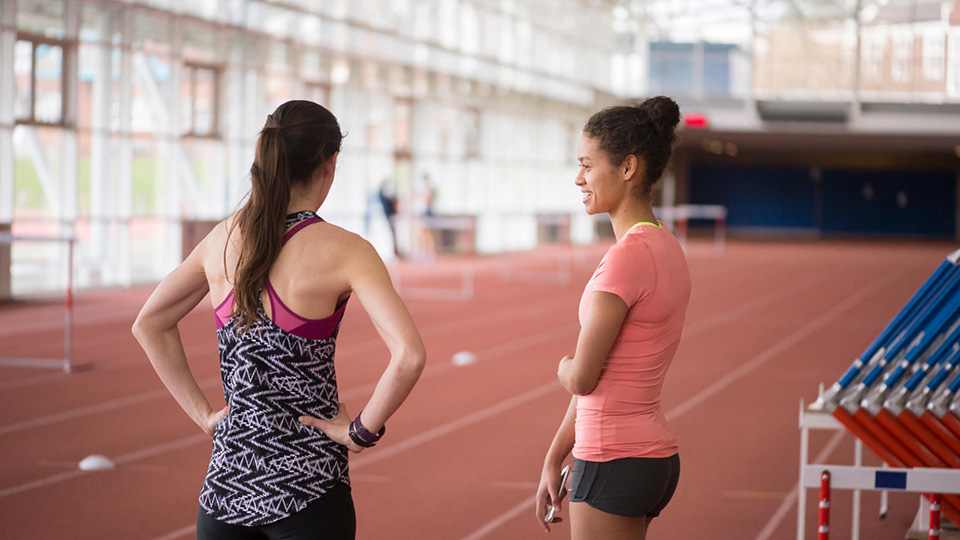 Athletes talking on running track