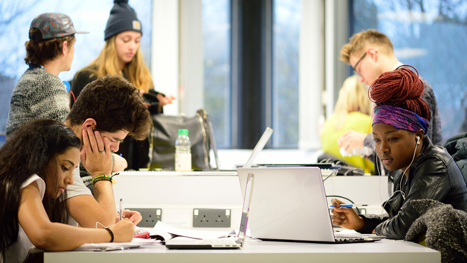 Student using a laptop in the library