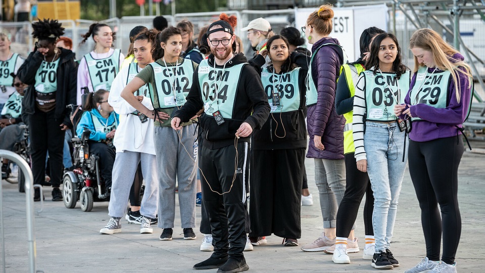 A mixed group of people wait to take part in a Critical Mass cycling event.
