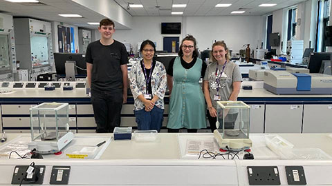 Four people stood in the biosciences lab