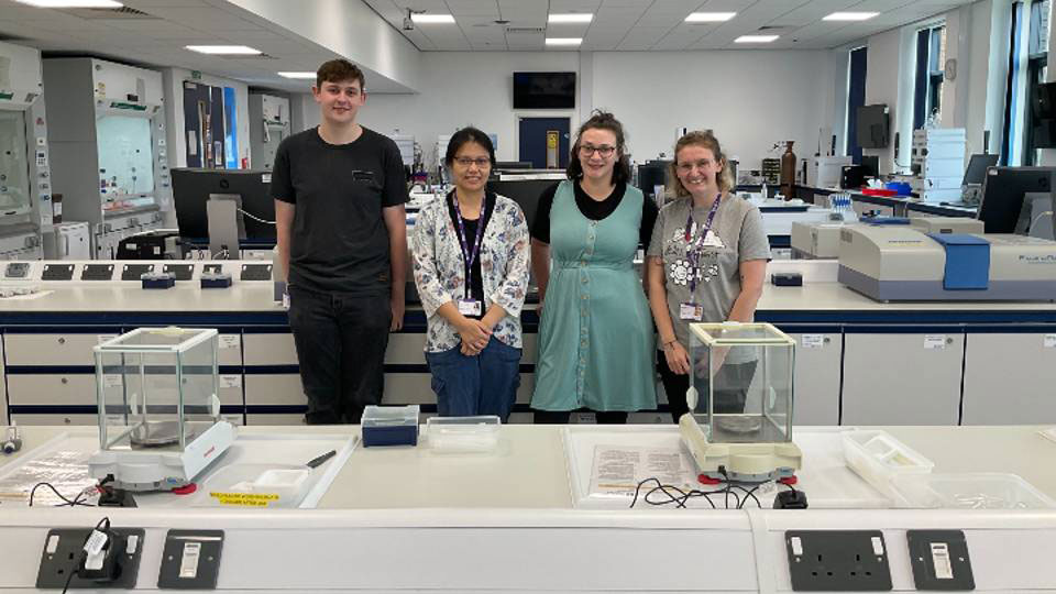 Four people stood in the biosciences lab