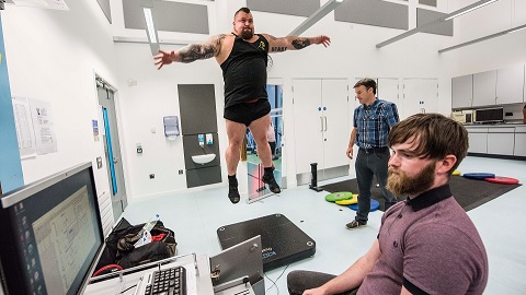 Deadlift champion Eddie Hall pictured mid-jump on a force plate while Loughborough University sport scientists monitor him