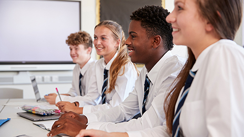 A group of students sitting in a school classroom