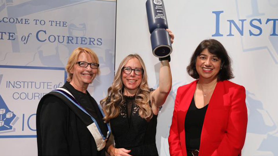 A group celebrating with a trophy
