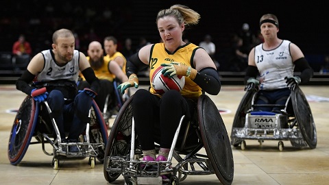 A picture of wheelchair rugby players in action.