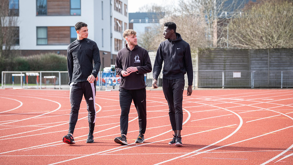3 athletes on running track