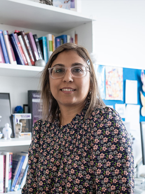 prof fehmidah munir inside her office with bookshelf background