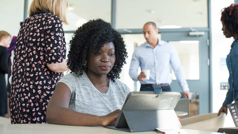 Student typing on tablet computer