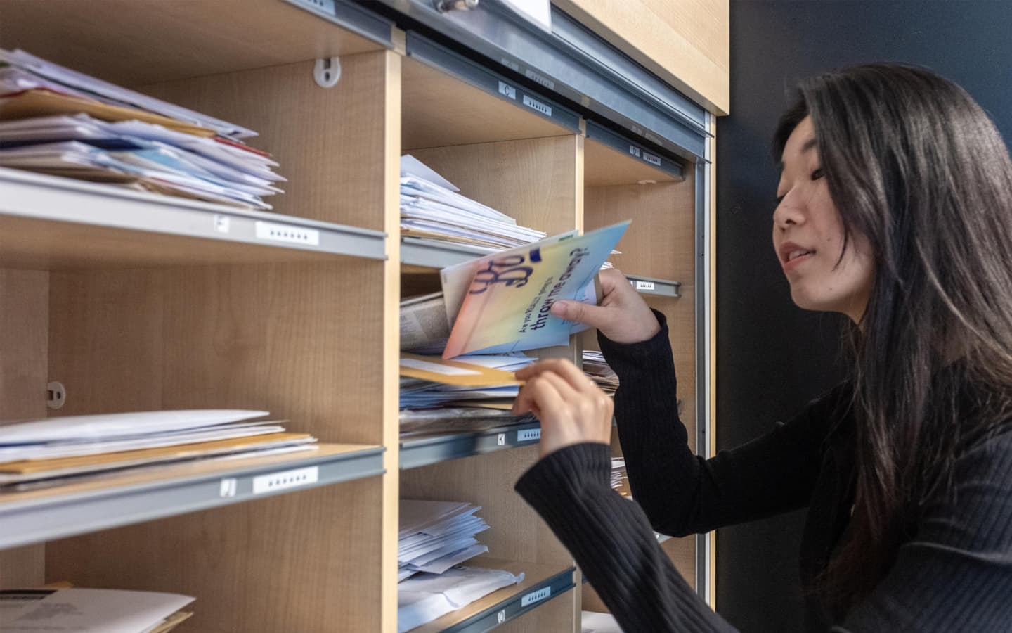 A student collecting mail from her hall reception