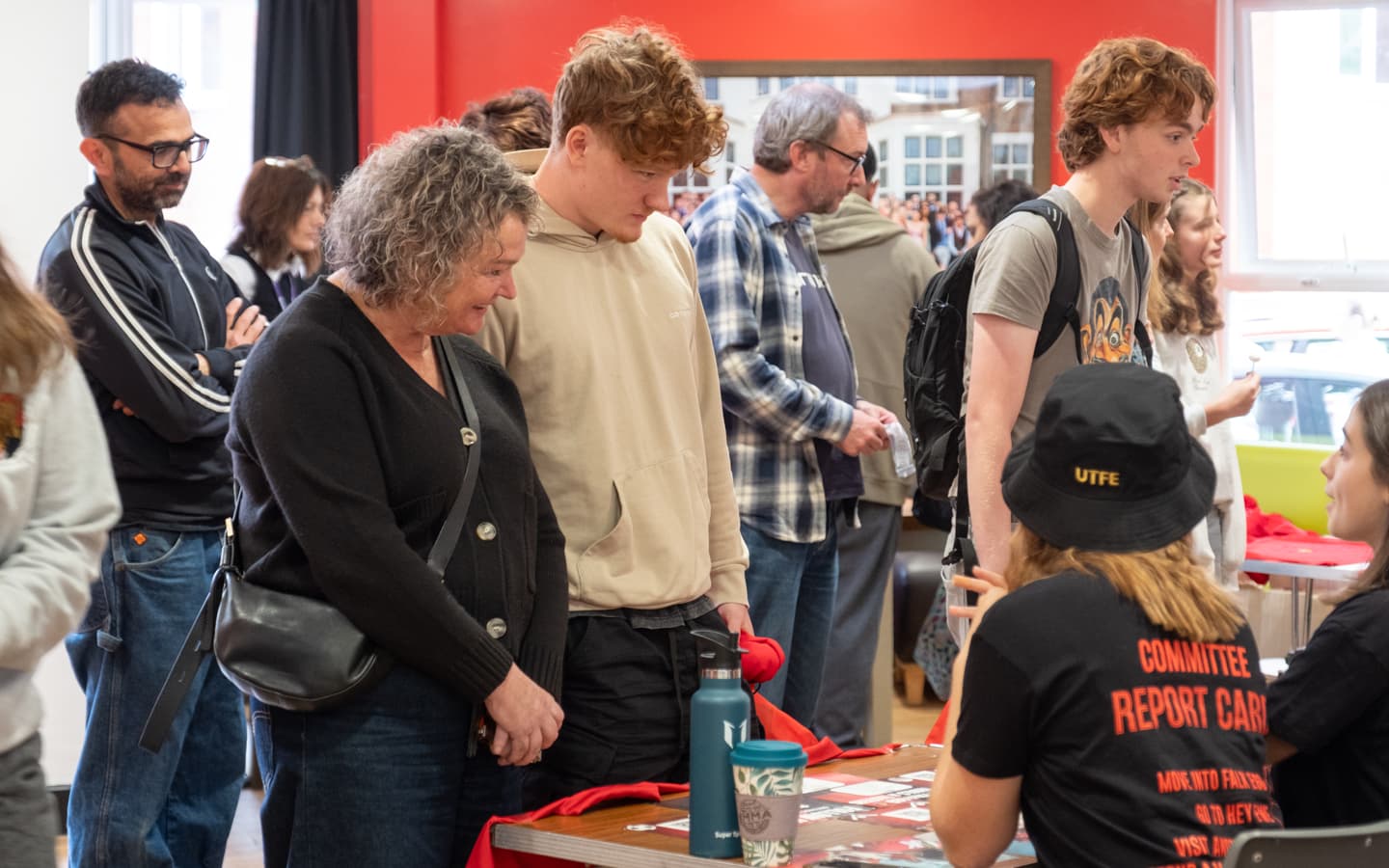 Committee speaking with parents and students about hall activities