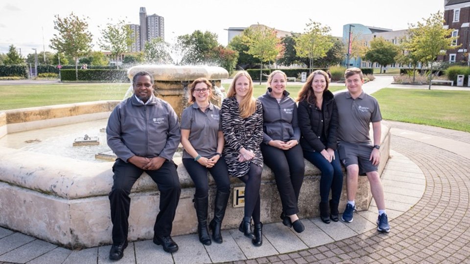 Accommodation wardens sat around the Hazlerigg fountain at Loughborough University