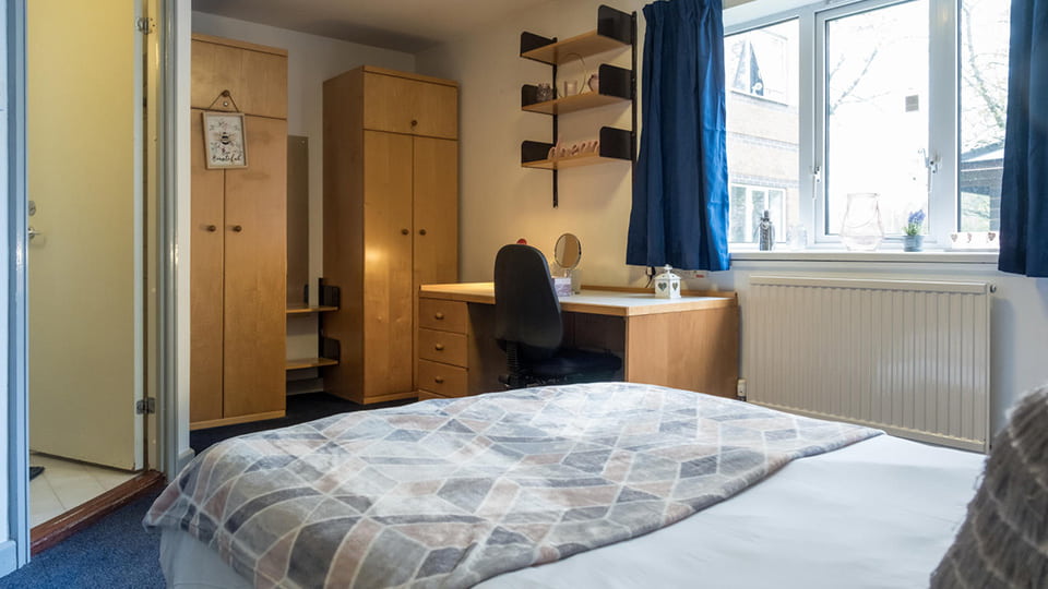 comfy Butler Court bedroom with en-suite bathroom, large bed, wardrobes and a study desk