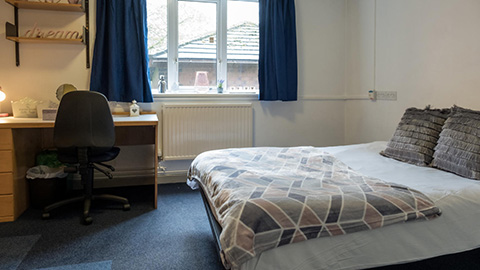 Butler Court en-suite bedroom showing off large comfy bed, study desk and large window with a view