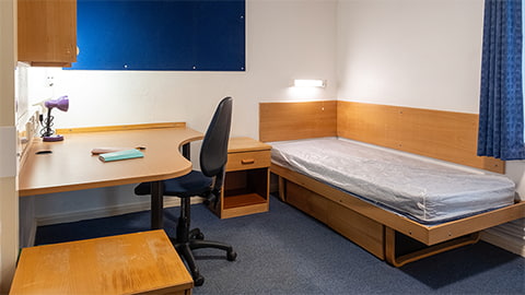 Cayley en-suite bedroom with study desk and storage spaces at Loughborough University
