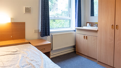 Cayley standard room in the traditional student halls of residence with bed, desk and washbasin