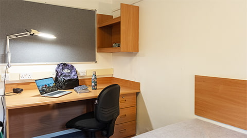 Desk space with chair and storage options in a traditional standard bedroom in Cayley student accommodation