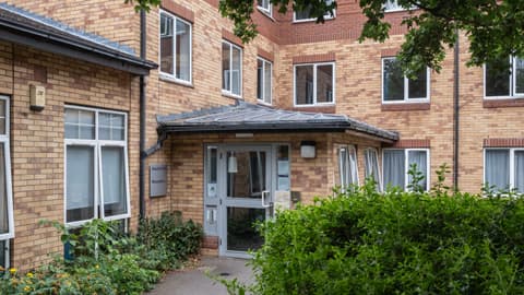 David Collett Reception, a grey door, surrounded by greenery