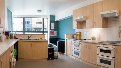 Spacious kitchen and dining area in each Elvyn Richards flat. There are two ovens and lots of cupboard space for each student, as well as a sofa area with table and additional chairs.