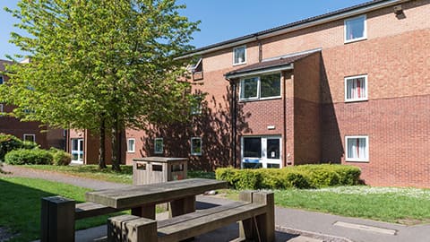 Exterior of modern Royce blocks with wooden picnic bench outside