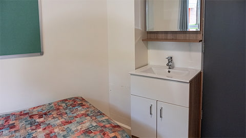 A hand-wash basin and mirror inside every room at Telford student accommodation