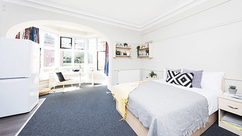 Large studio in The Holt accommodation with double bed, study desk and kitchen