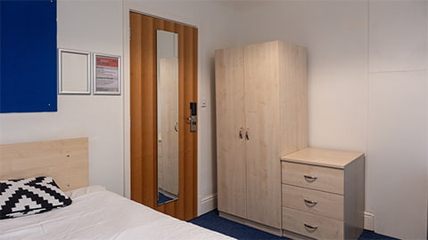 A standard bedroom in William Morris Highfields block with wardrobe and drawer storage