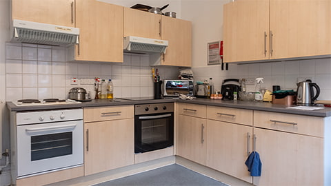 Kitchen in standard rooms at William Morris student accommodation with ovens, hobs, fridges and cupboard spaces for students