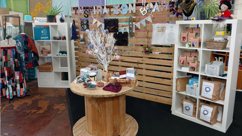 A store display featuring various items neatly arranged on shelves, showcasing a variety of products for customers.
