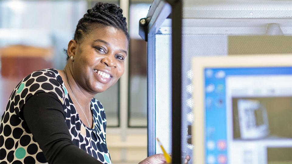 A smiling professor at work in her lab.