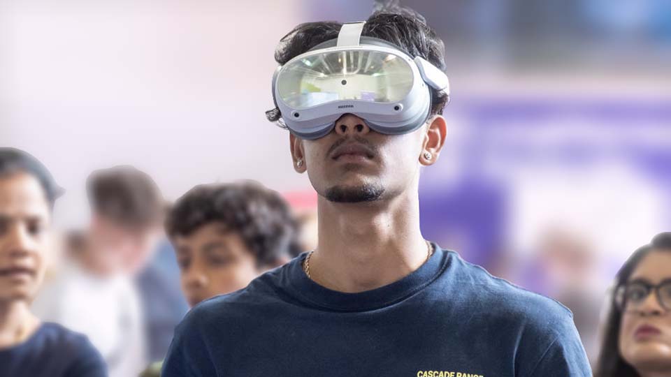 A student wearing VR display goggles at a University Open Day.