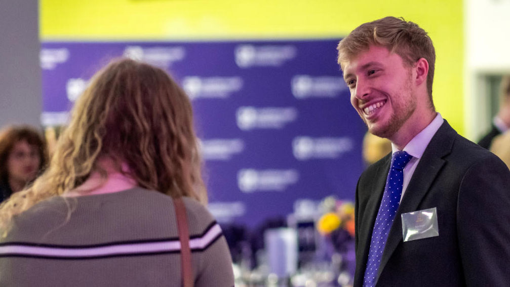 Doctoral researchers networking at the awards event.