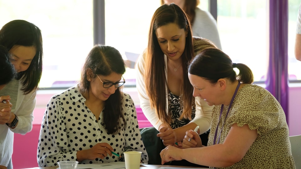 Four members of staff in discussion