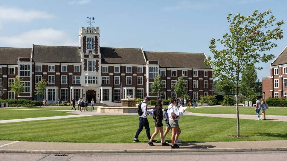Hazlerigg Building and people walking by looking at a map