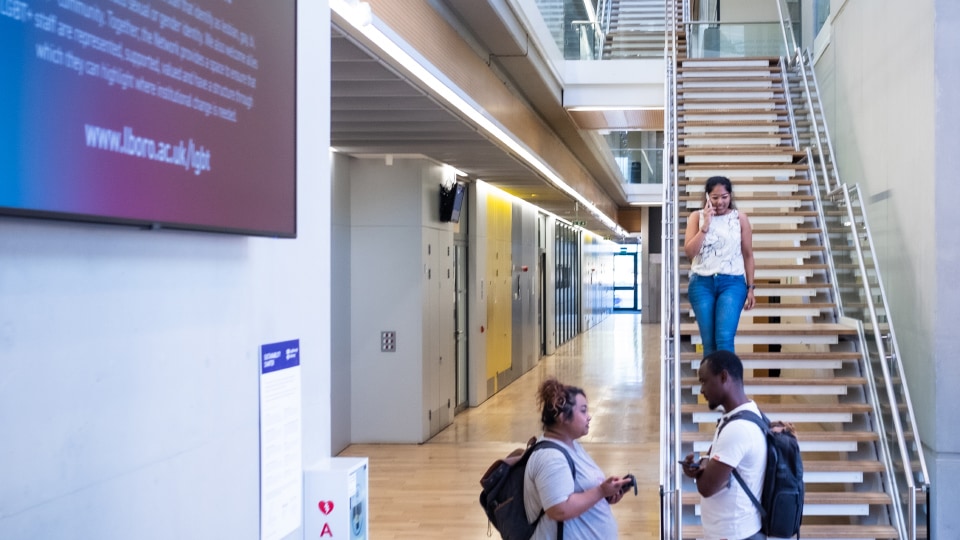 Student talking and another student talking on mobile phone