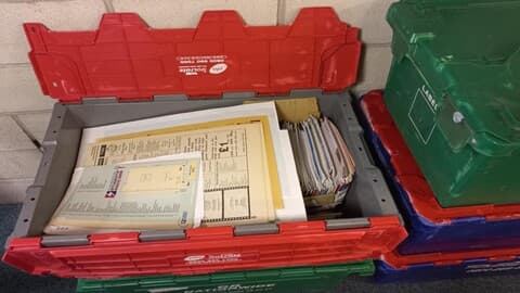 Selection of open and closed plastic crates containing Loughborough Students Union publications.